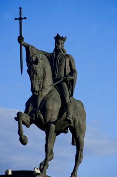 romanian national hero Stefan cel Mare holding the holy cross in his hand while riding his horse