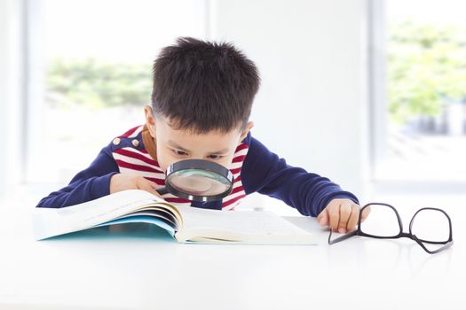 little boy detective searching clues from books