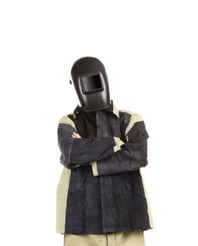 Welder in mask with arms crossed.