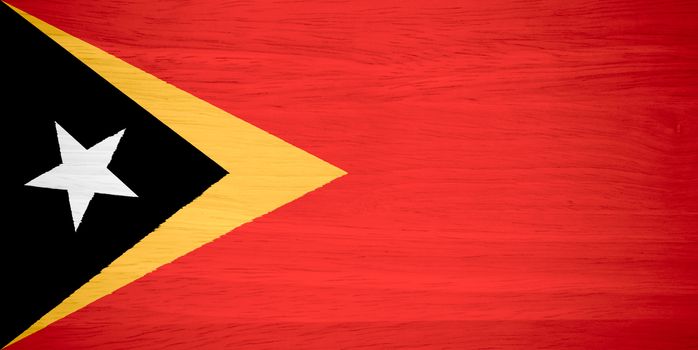 East Timor flag on wood texture
