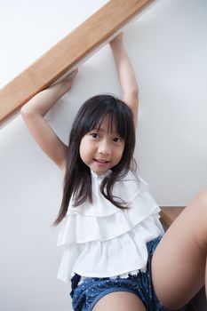 Girl sitting in on the ladder