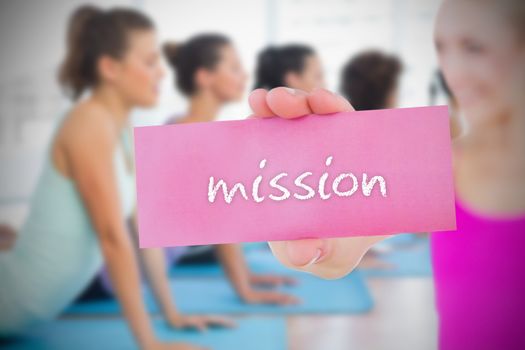 Fit blonde holding card saying mission