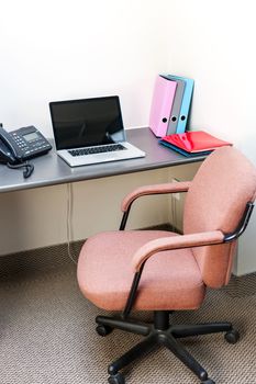 Office cubicle with laptop computer