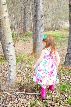 Little girl playing in the field during springtime