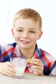 Cute boy with glass of milk