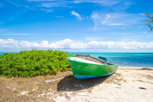 Old fishing boat on a tropical beach at the Caribbean
