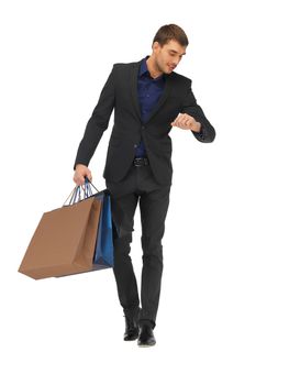 handsome man in suit with shopping bags
