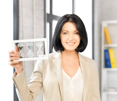 businesswoman holding hourglass