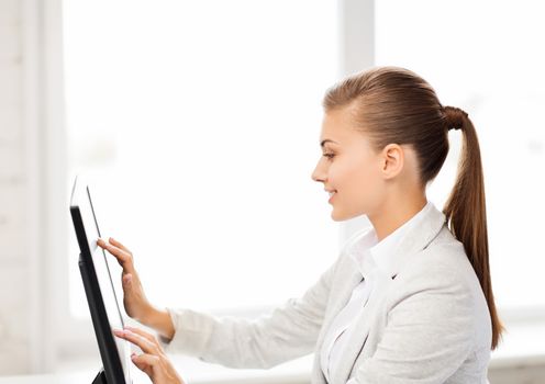 smiling businesswoman with touchscreen in office