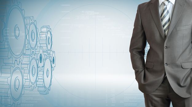 Businessman with high-tech gears and graphs