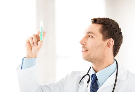 male doctor holding syringe with injection