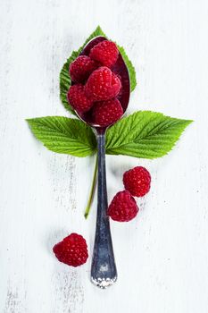 Fresh organic raspberry in a spoon.  Selective focus 