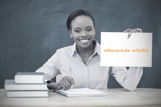 Happy teacher holding page showing extracurricular activities 