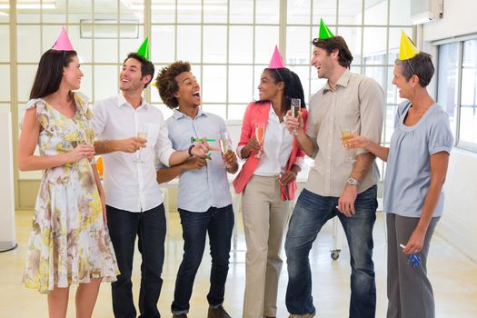 Coworkers laugh and celebrate accomplishment and enjoy party