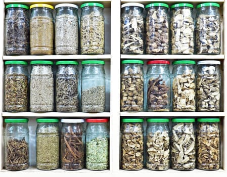 Assortment of glass jars on shelves in herbalist shop in marrake