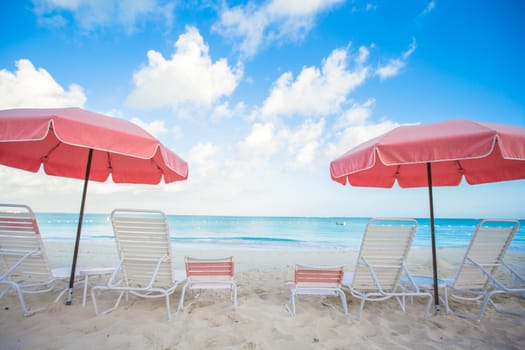 Chairs and umbrellas on stunning tropical beach