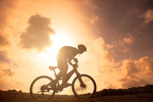 The silhouette of mountain bicycle rider on the hill