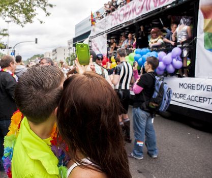 Young couple make selfie during parade