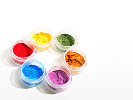 A colorful group of brilliantly hued powder eyeshadows.  