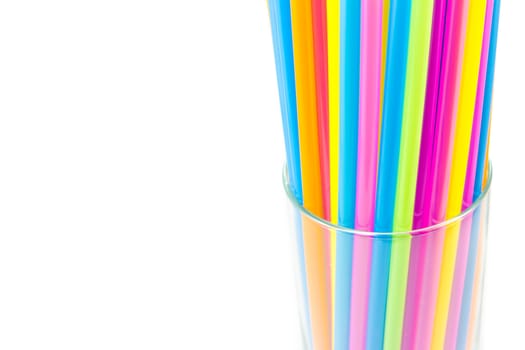Colorful drinking straws in glass isolated on white background