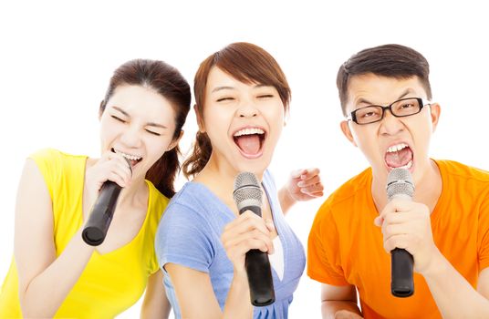 happy young group having fun singing with karaoke