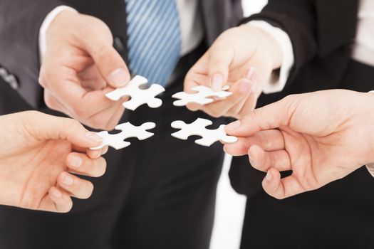 Business people Holding Jigsaw Puzzle