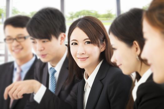 shot of focus on young business woman with colleagues