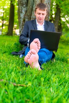 a man with a laptop with bare feet