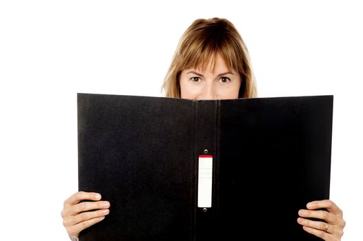 Woman hiding face with business file