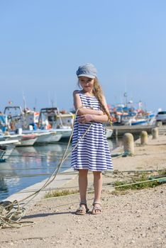 Adorable little girl in dress at fisherman village in Portugal