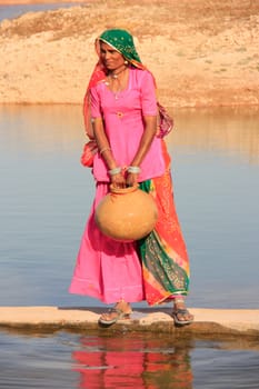 Local woman getting water from reservoir, Khichan village, India