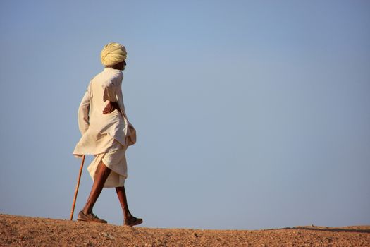 Local man walking on a hill, Khichan village, India