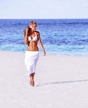 Hot girl walking on the beach
