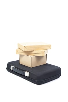 Many brown paper box on a black briefcase in studio white isolated background.