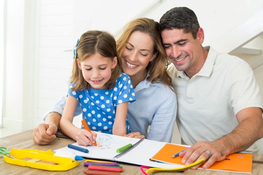 Parents looking at girl coloring