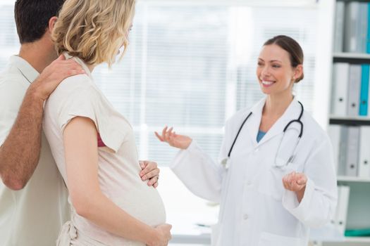 Gynaecologist welcoming expectant couple