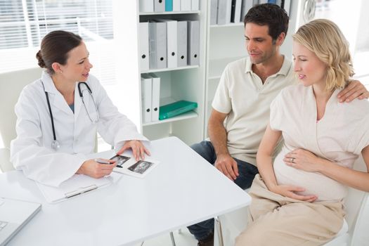 Gynaecologist explaining reports to expectant couple