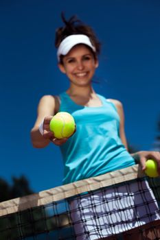 Female playing tennis on court