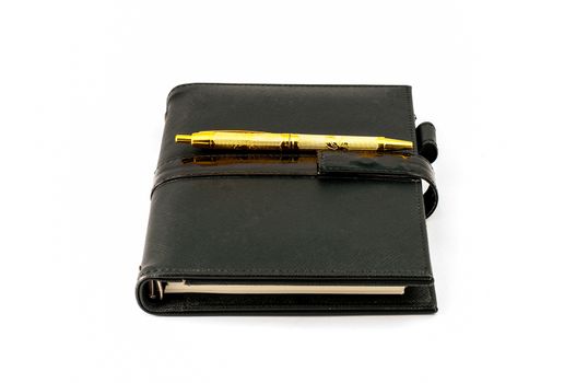 Black note book with ballpoint pen