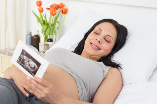 Pregnant woman looking at sonography report