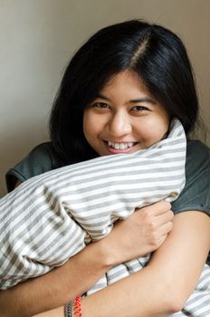 Funny woman holding pillow 