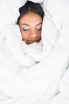 Sleeping girl wrapped up in her duvet 