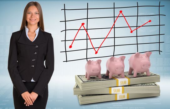 Businesswoman with piggy banks and money