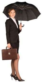 Businesswoman holding a briefcase and umbrella