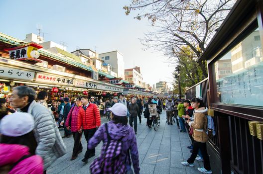 Tokyo, Japan - November 21, 2013: Tourists visit Nakamise shopping street