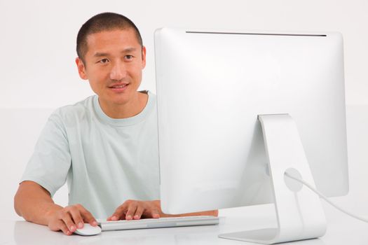 Happy young man using computer