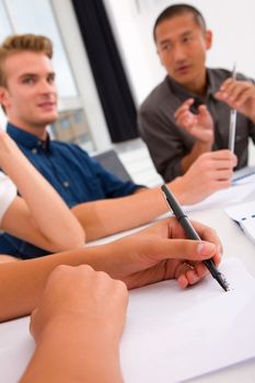 Businesswoman taking note in meeting