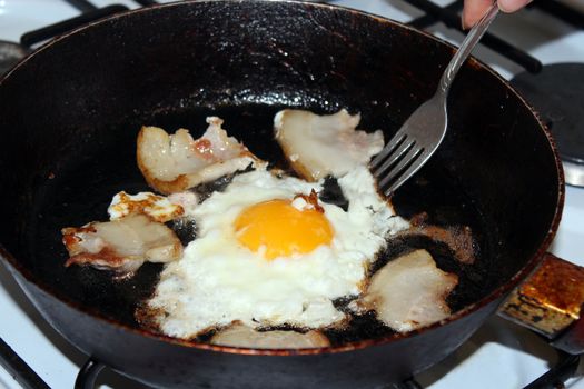 Fried egg during cooking