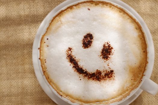 Coffee cappuccino foam or chocolate smiling happy face