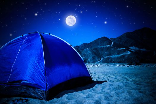 Camp tent on the beach at night